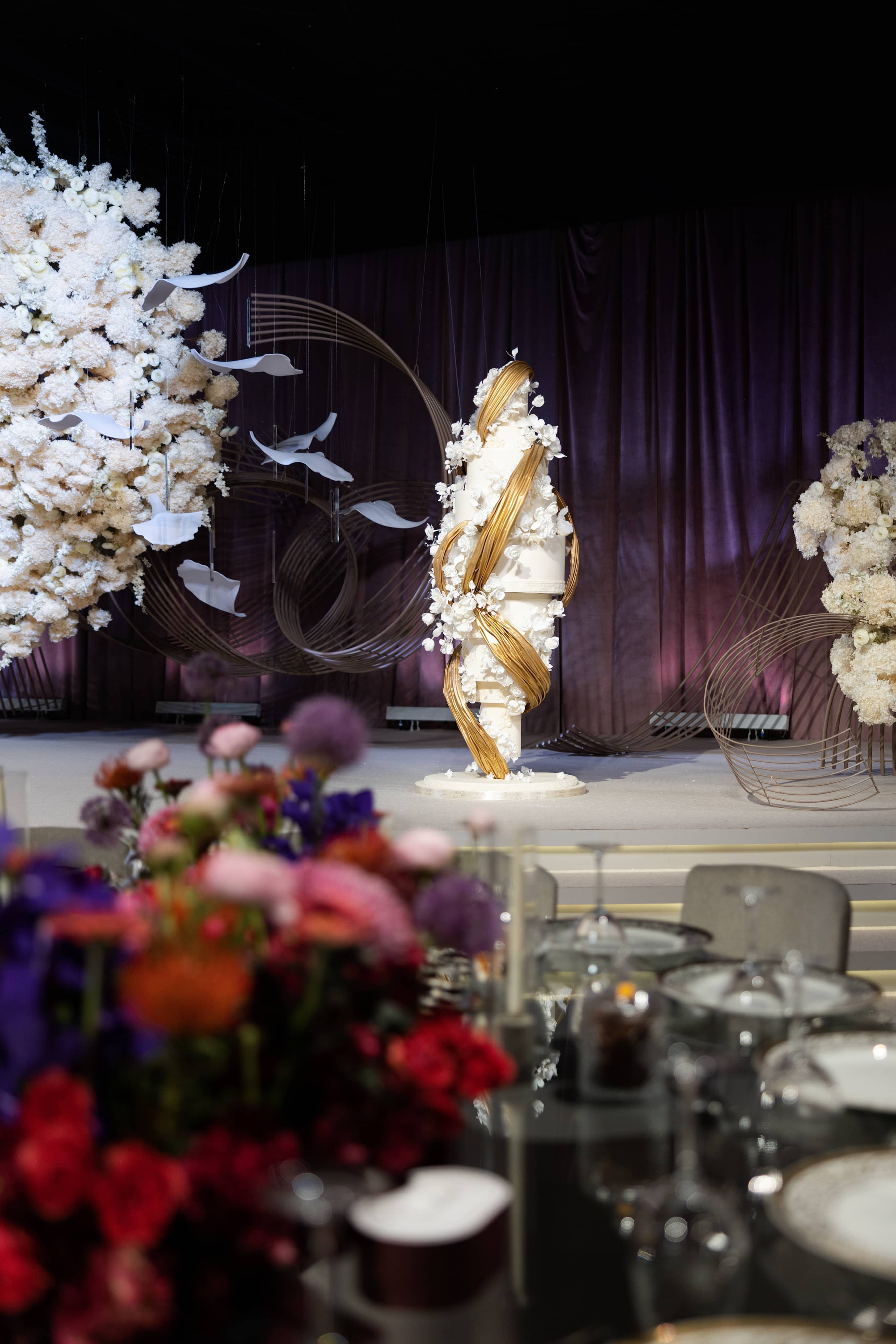 Tall white floral arrangement at the event.