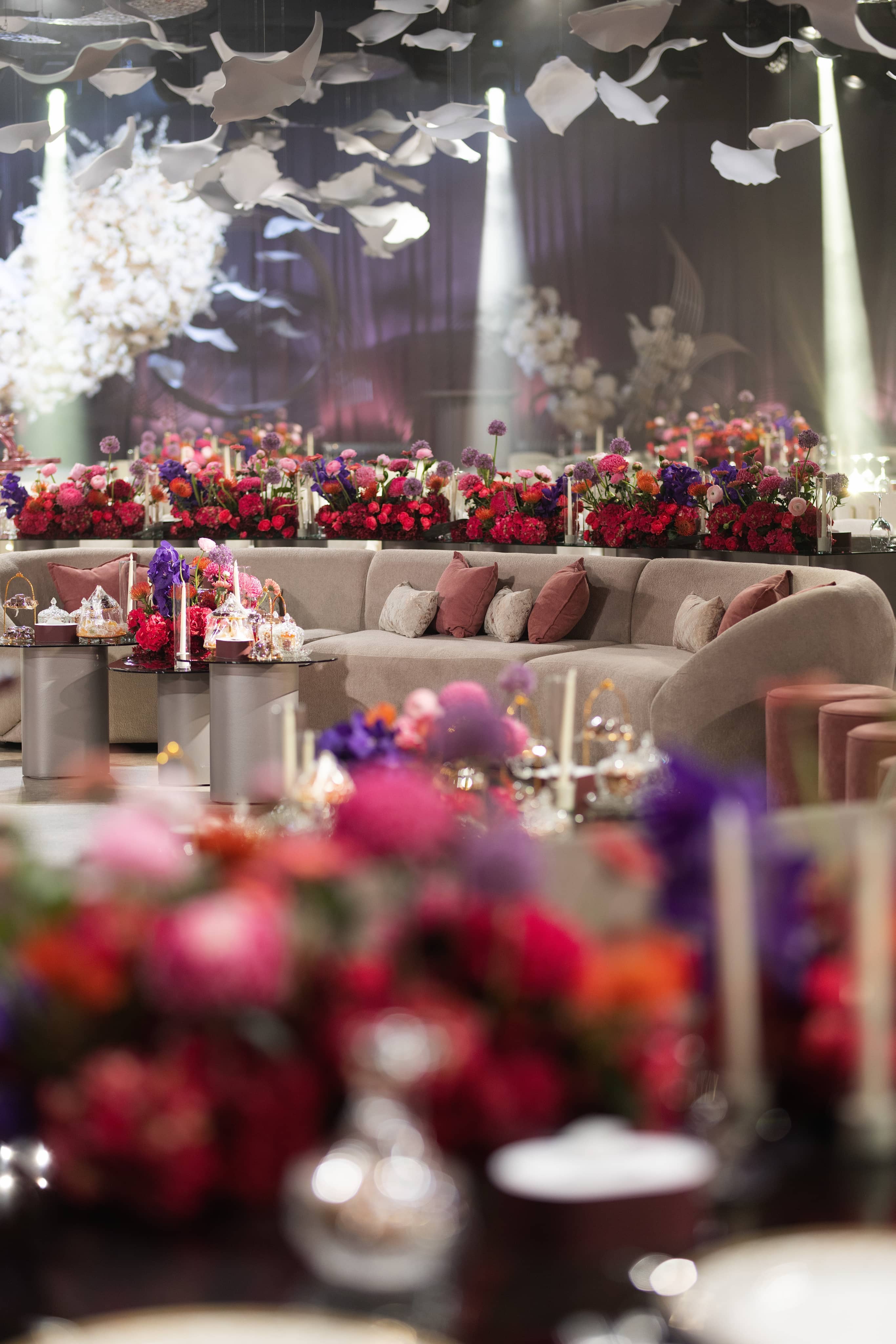 Floral centerpieces on a lounge table with soft depth of field.